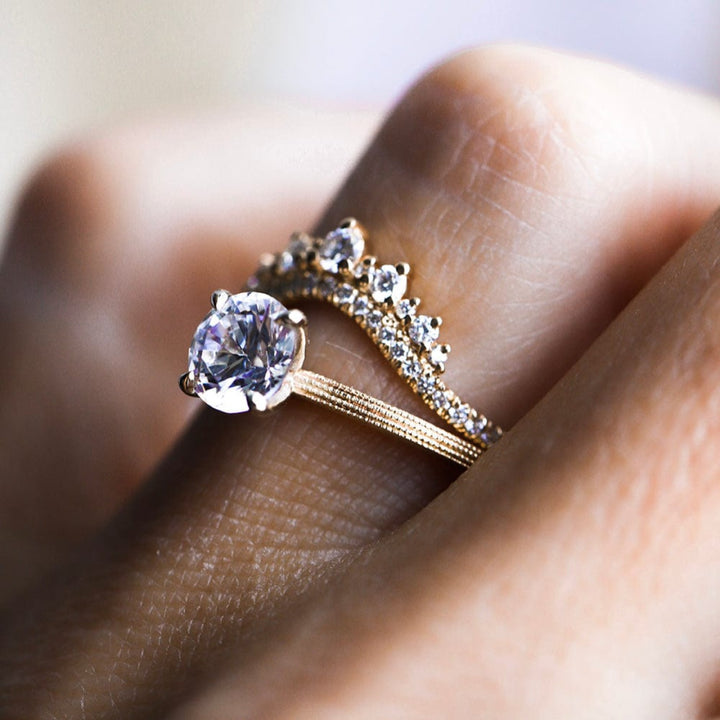 Round moissanite solitaire engagement ring with elegant band