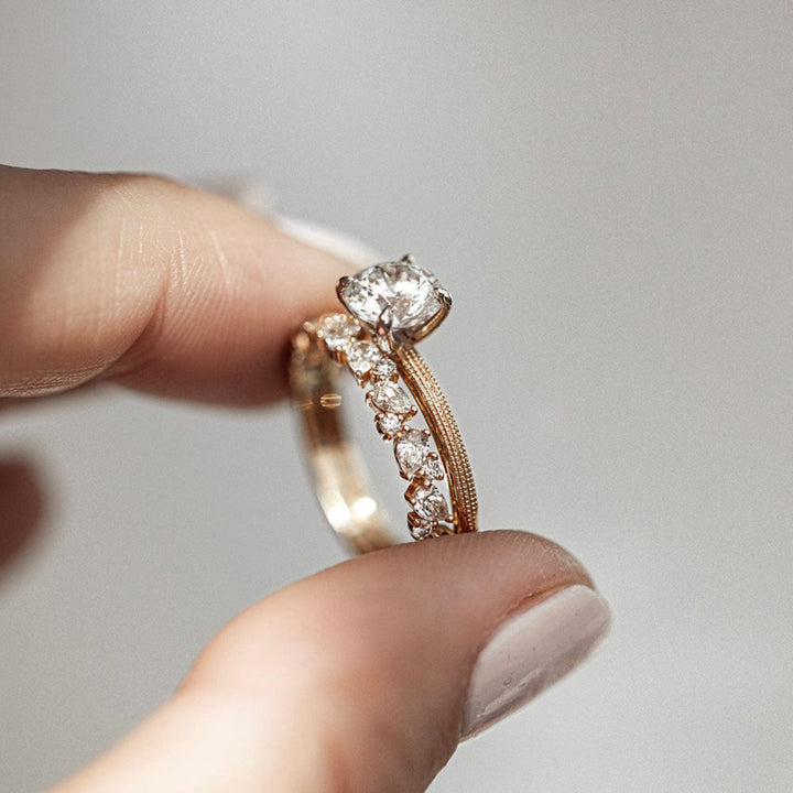 Round moissanite solitaire engagement ring with elegant band