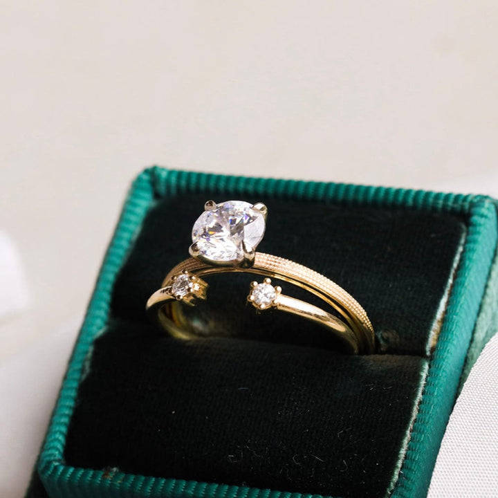 Round moissanite solitaire engagement ring with elegant band