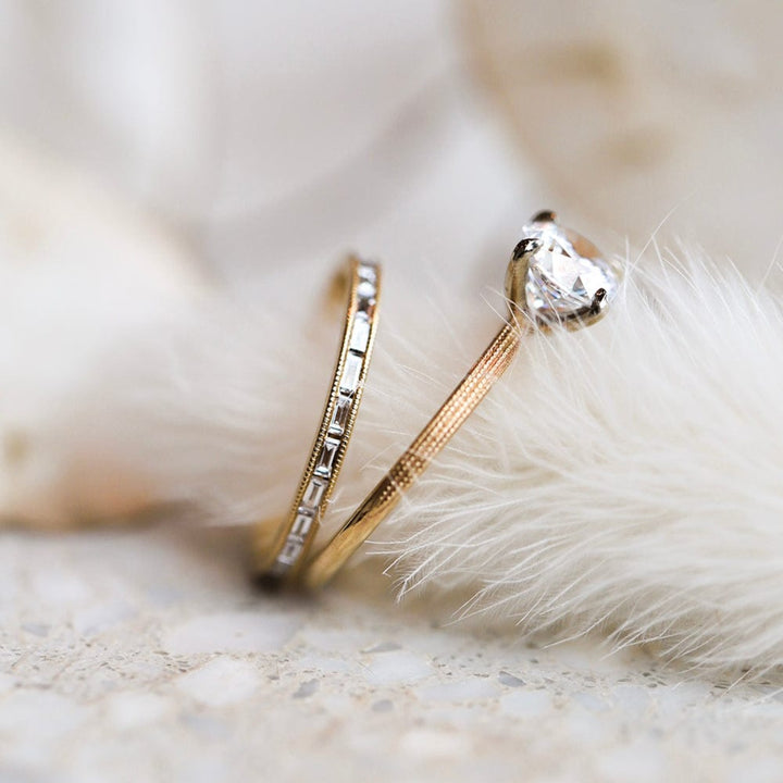 Round moissanite solitaire engagement ring with elegant band