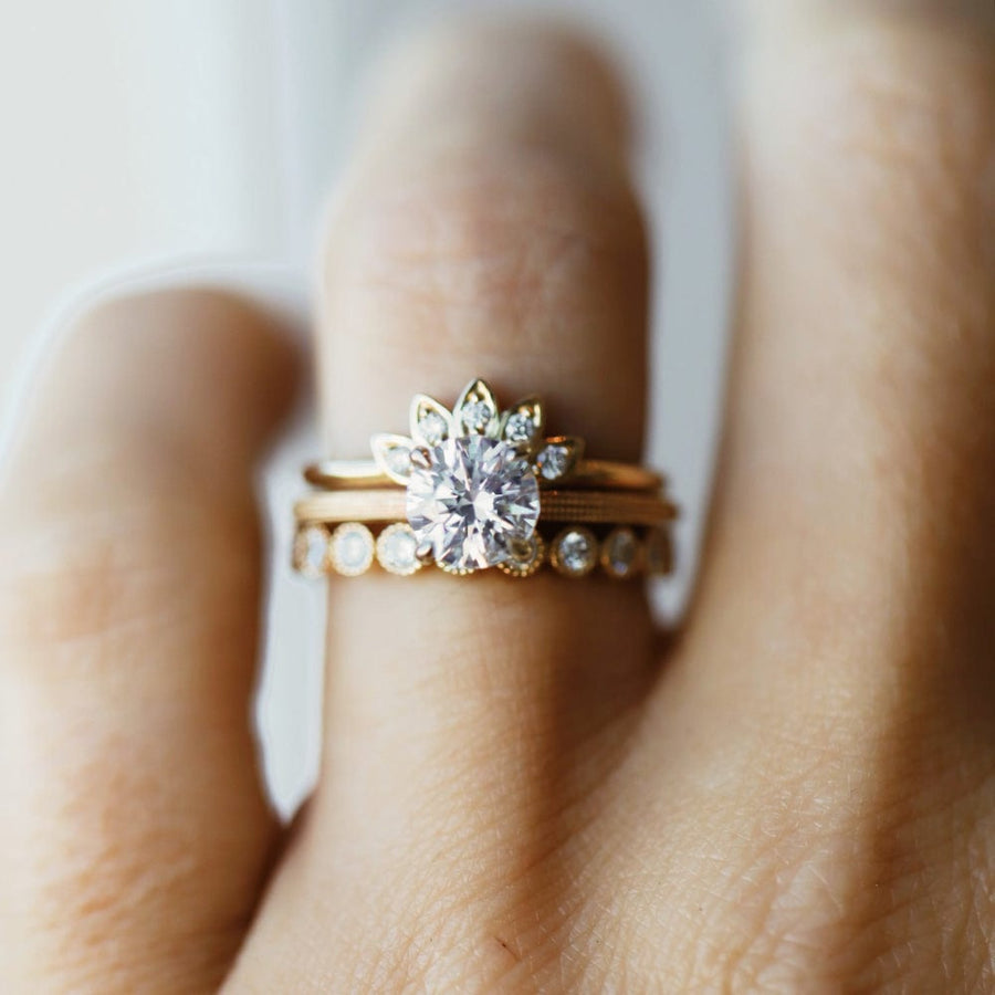 Round moissanite solitaire engagement ring with elegant band