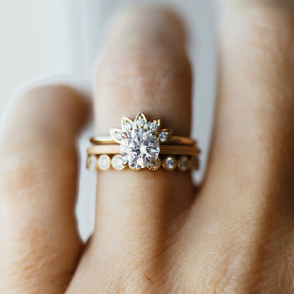 Round moissanite solitaire engagement ring with elegant band