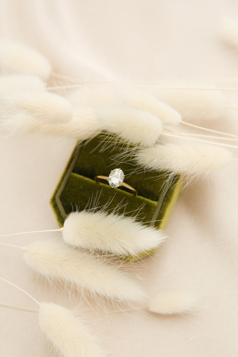 Elegant solitaire engagement ring with oval cut moissanite
