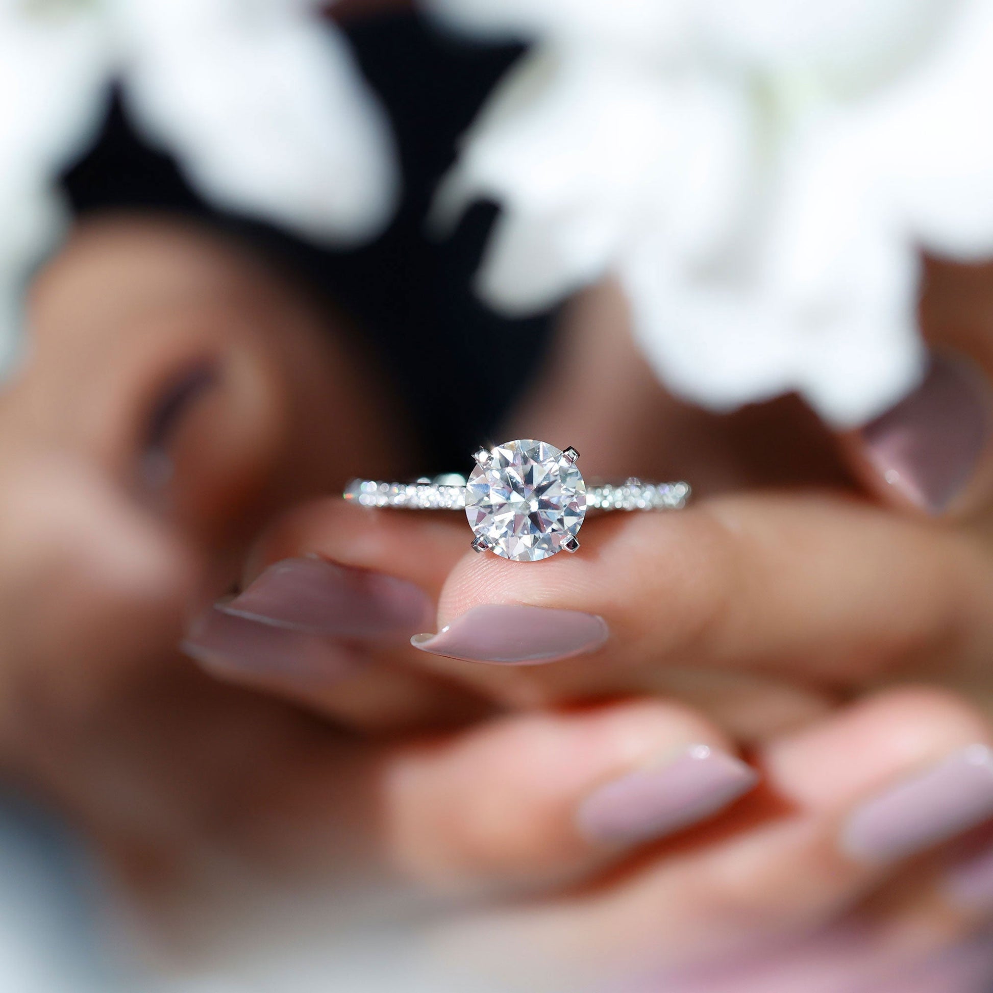 Round cut moissanite pave engagement ring with sparkling band
