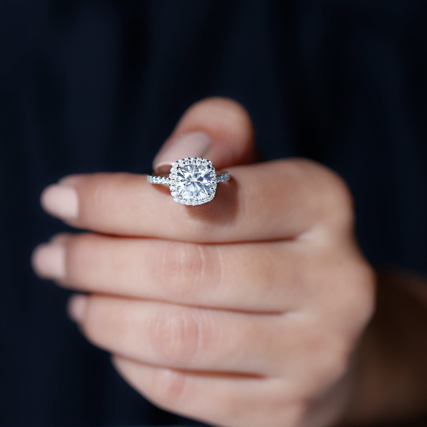 Cushion cut moissanite engagement ring with halo setting