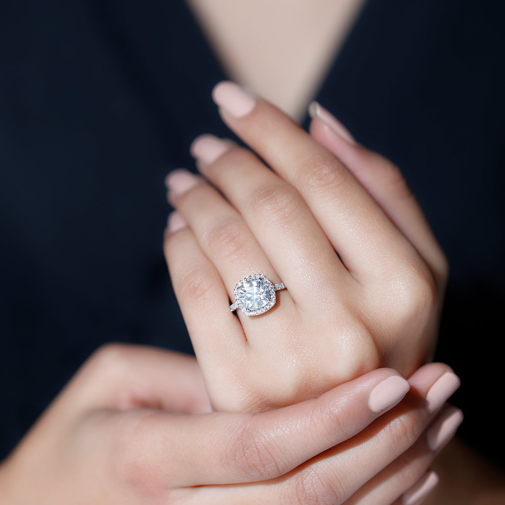 Cushion cut moissanite engagement ring with halo setting