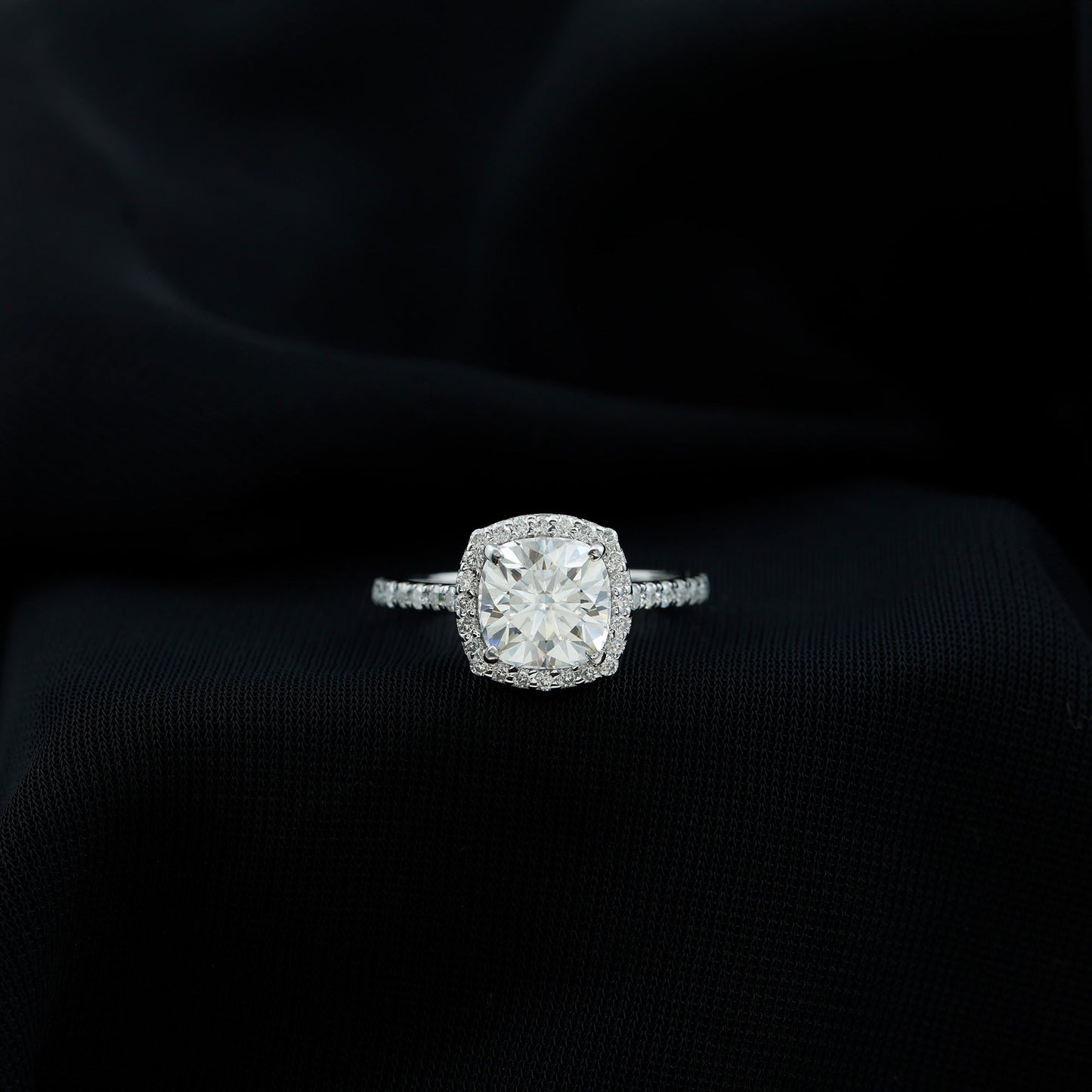 Cushion cut moissanite engagement ring with halo setting