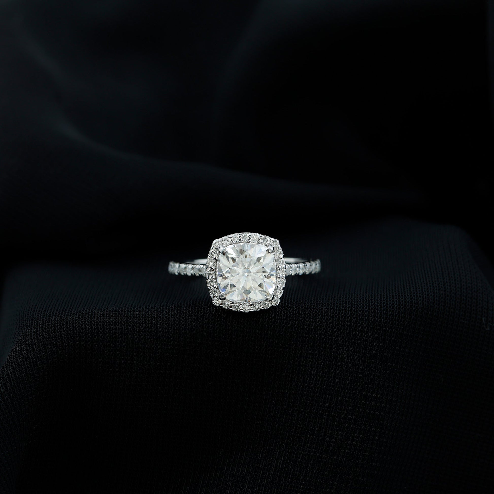Cushion cut moissanite engagement ring with halo setting