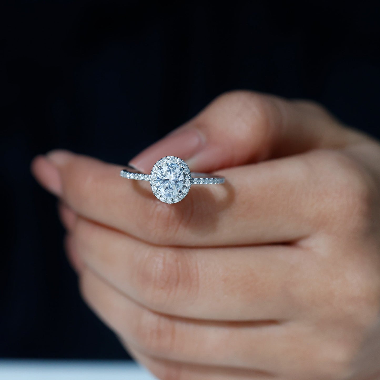 Oval cut moissanite halo engagement ring with elegant sparkle