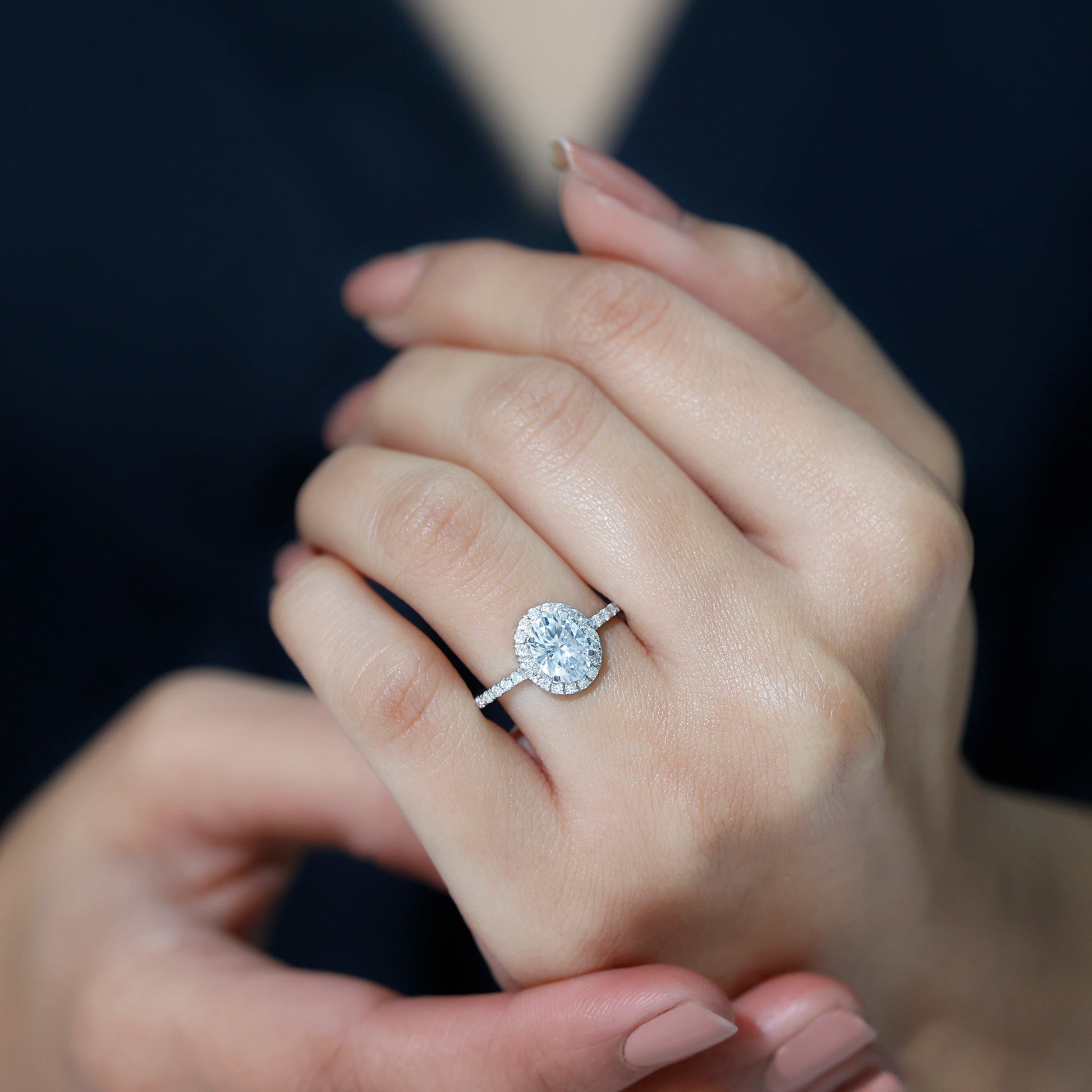 Oval cut moissanite halo engagement ring with elegant sparkle