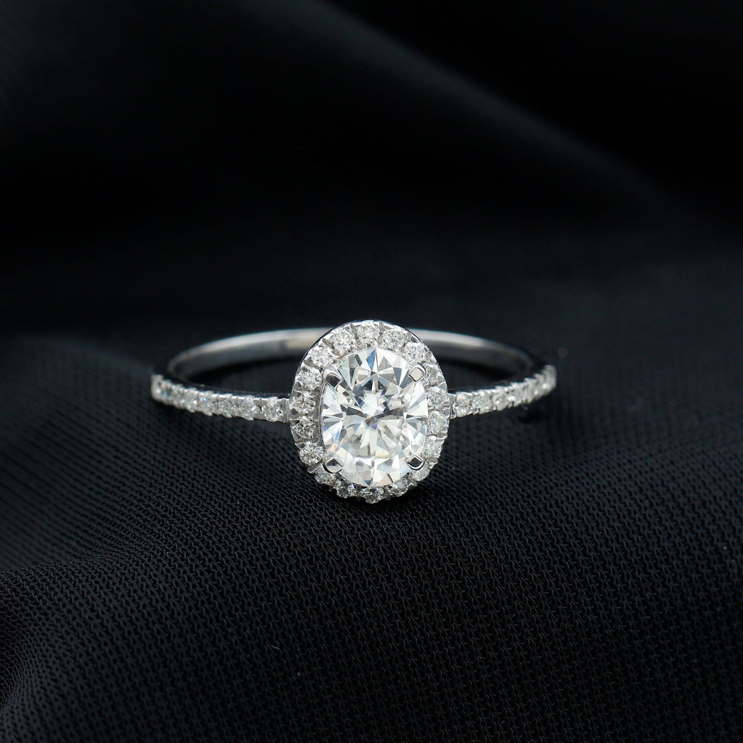 Oval cut moissanite halo engagement ring with elegant sparkle