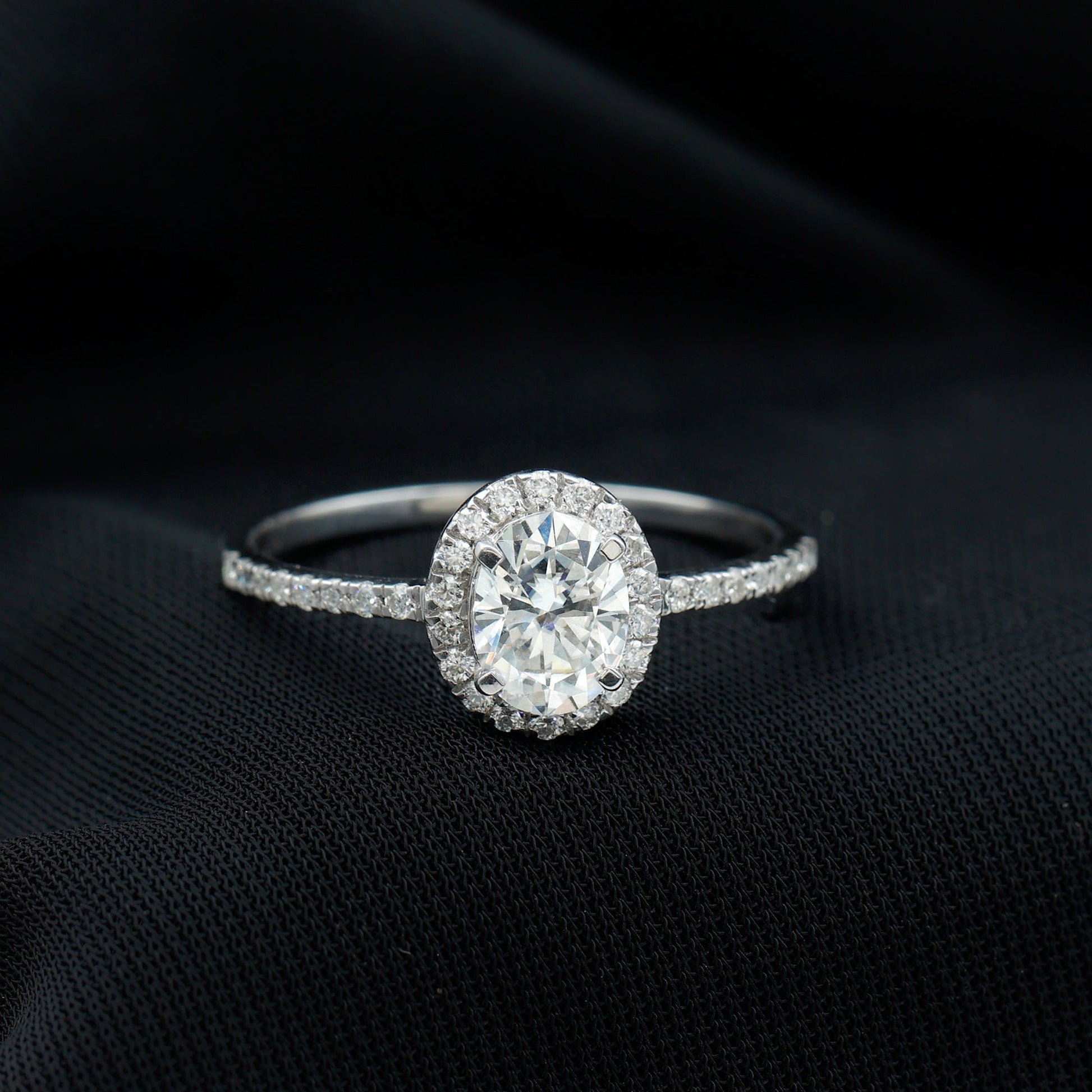 Oval cut moissanite halo engagement ring with elegant sparkle