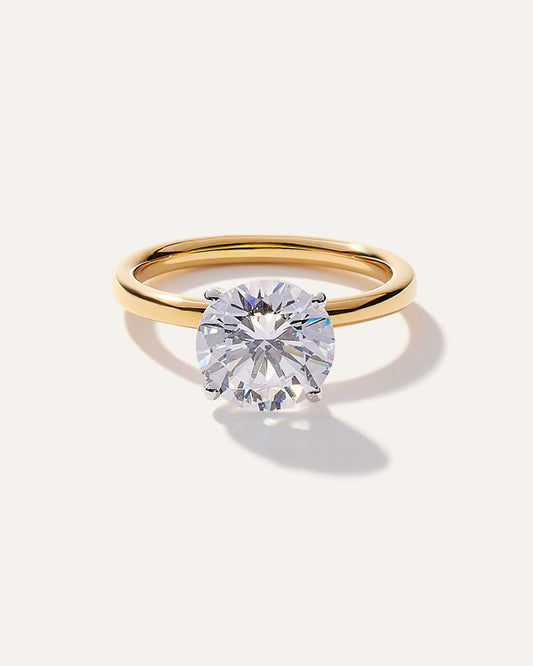 Round cut CVD lab grown diamond solitaire engagement ring with classic prong setting and polished metal band