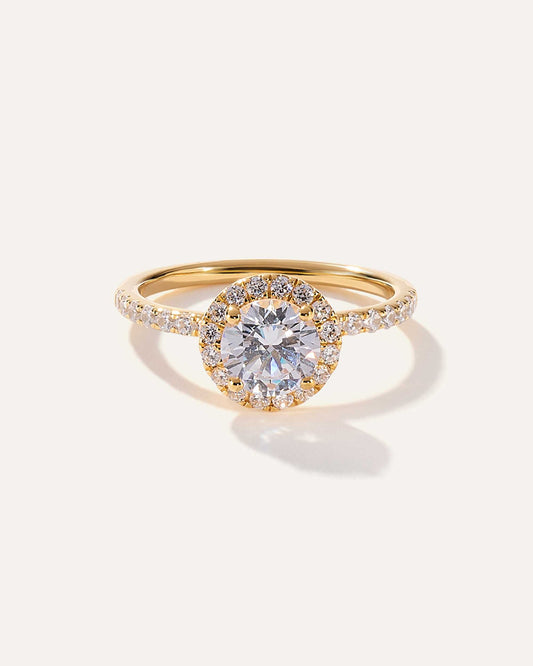 Round cut CVD lab grown diamond engagement ring with halo setting and pave band in a timeless elegant design