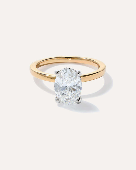 Oval cut CVD lab grown diamond hidden halo engagement ring with pave accents and a sleek polished band for classic elegance