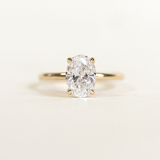Oval cut CVD lab grown diamond engagement ring featuring a hidden halo under the center stone and a slim polished band