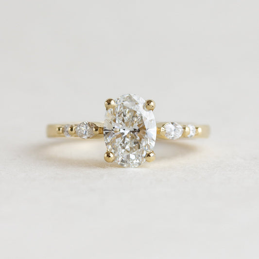 Oval cut CVD lab grown diamond five stone engagement ring with polished band and symmetrical setting