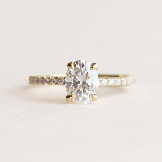 Oval cut CVD lab grown diamond pave engagement ring with slim band adorned with small round diamonds