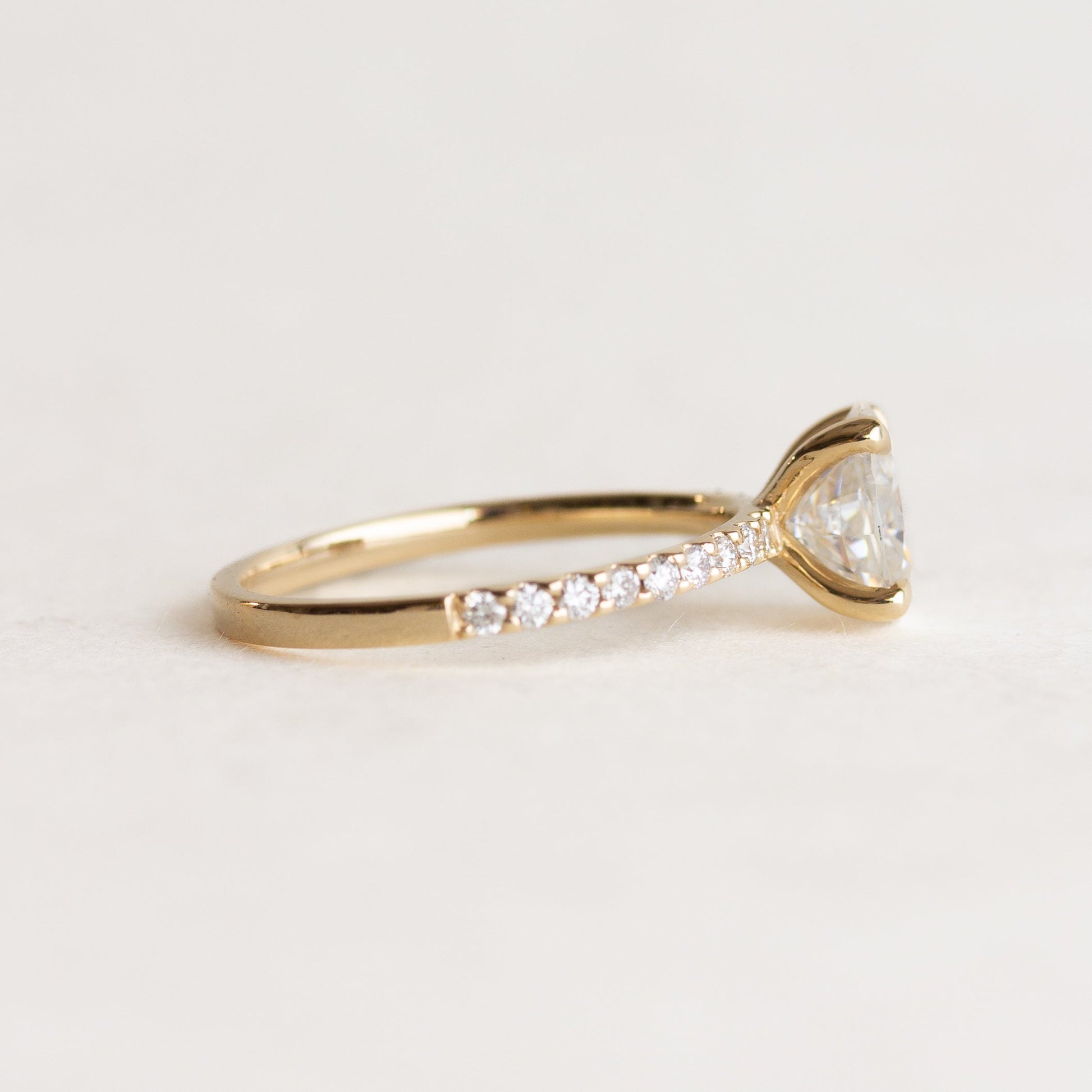 Oval cut CVD lab grown diamond pave engagement ring with slim band adorned with small round diamonds
