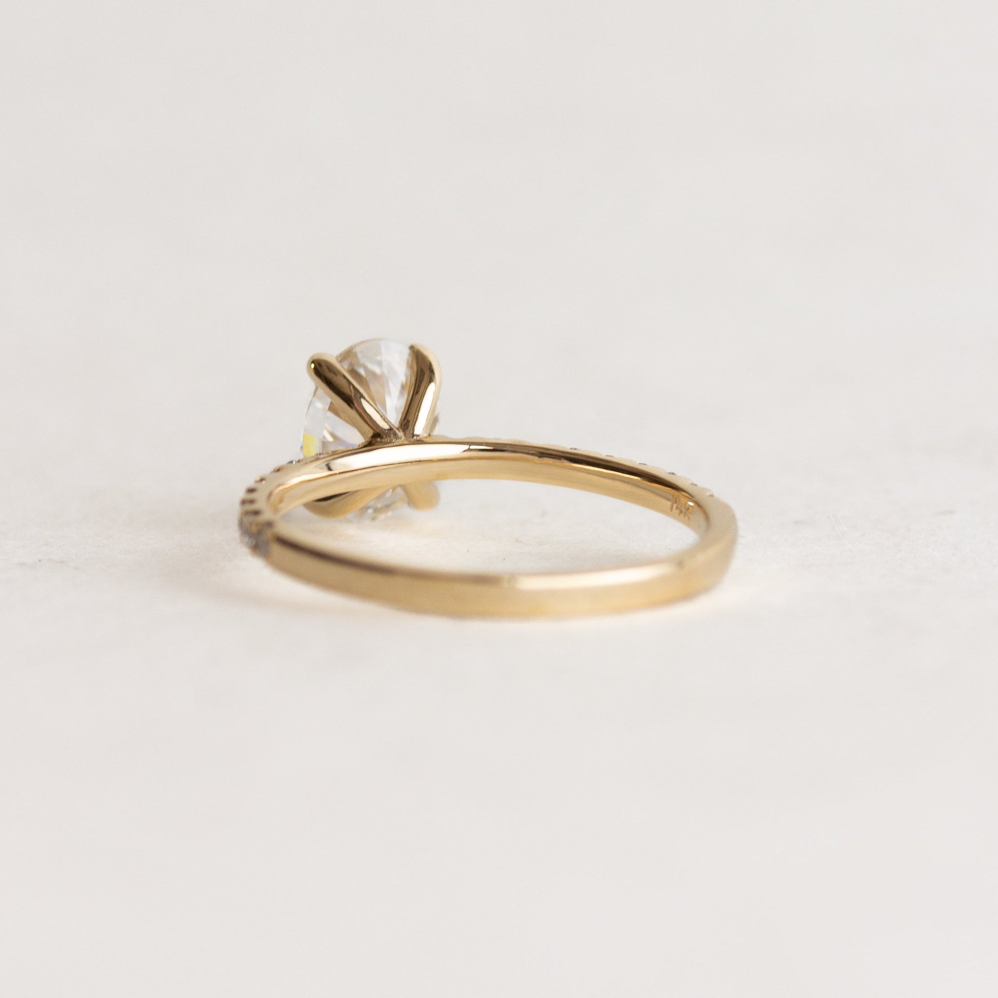 Oval cut CVD lab grown diamond pave engagement ring with slim band adorned with small round diamonds