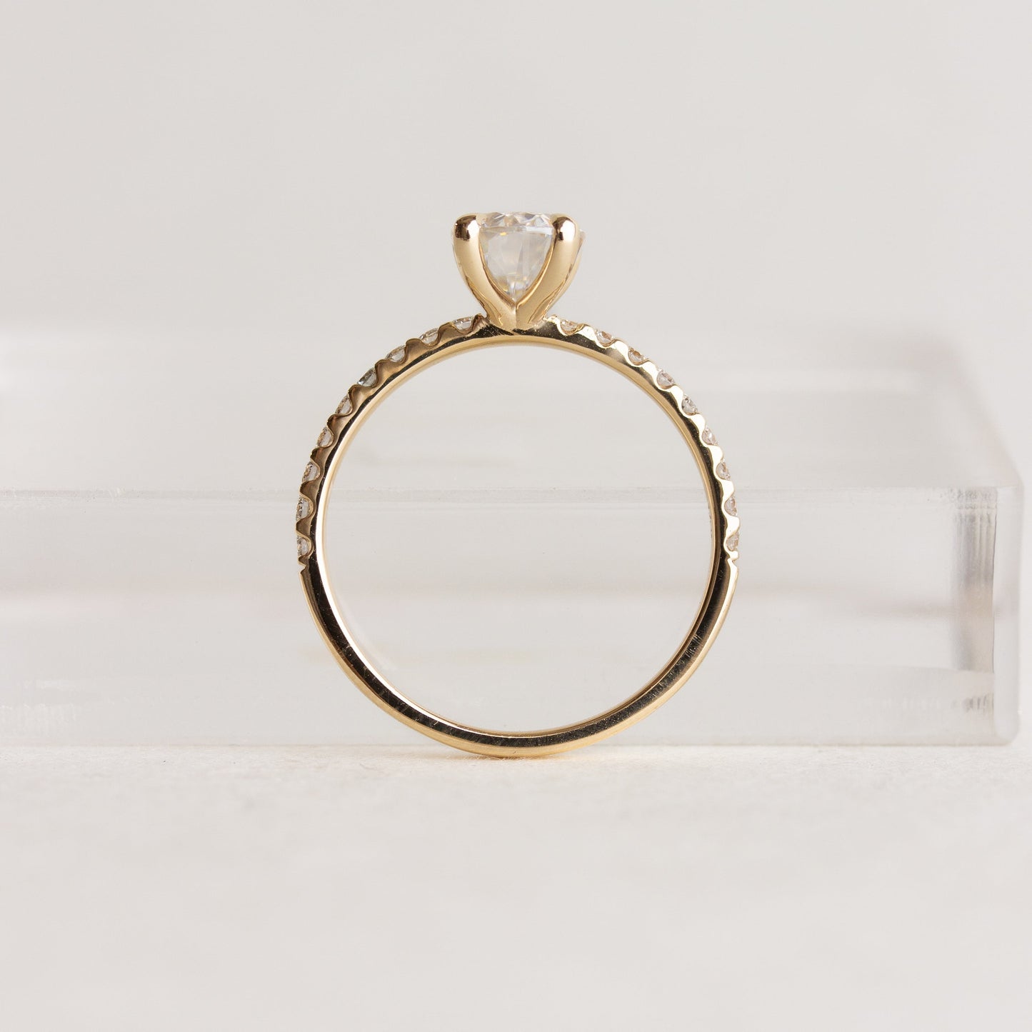 Oval cut CVD lab grown diamond pave engagement ring with slim band adorned with small round diamonds
