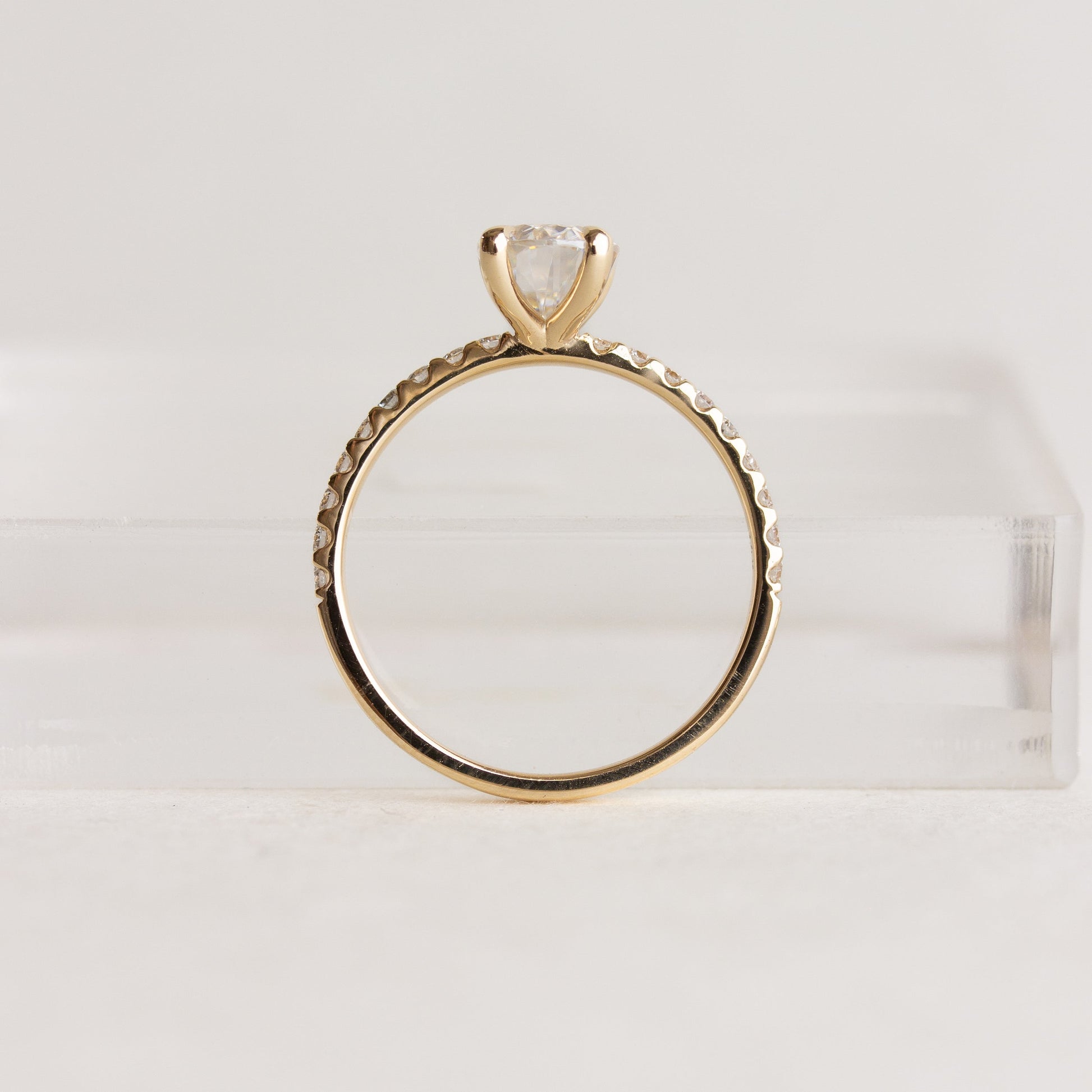 Oval cut CVD lab grown diamond pave engagement ring with slim band adorned with small round diamonds