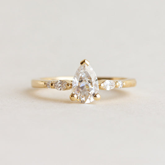 Pear cut CVD lab grown diamond five stone engagement ring with tapered band and prong-set diamonds