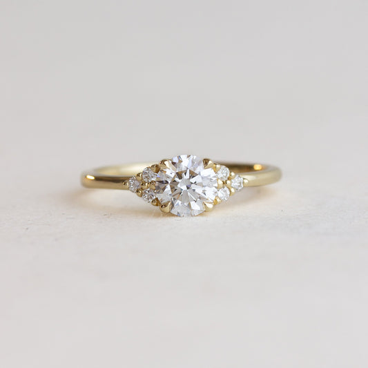 Round cut CVD lab grown diamond cluster engagement ring with multiple stones forming a brilliant floral-inspired setting