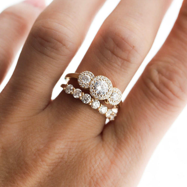 Three stone halo engagement ring with round cut moissanite