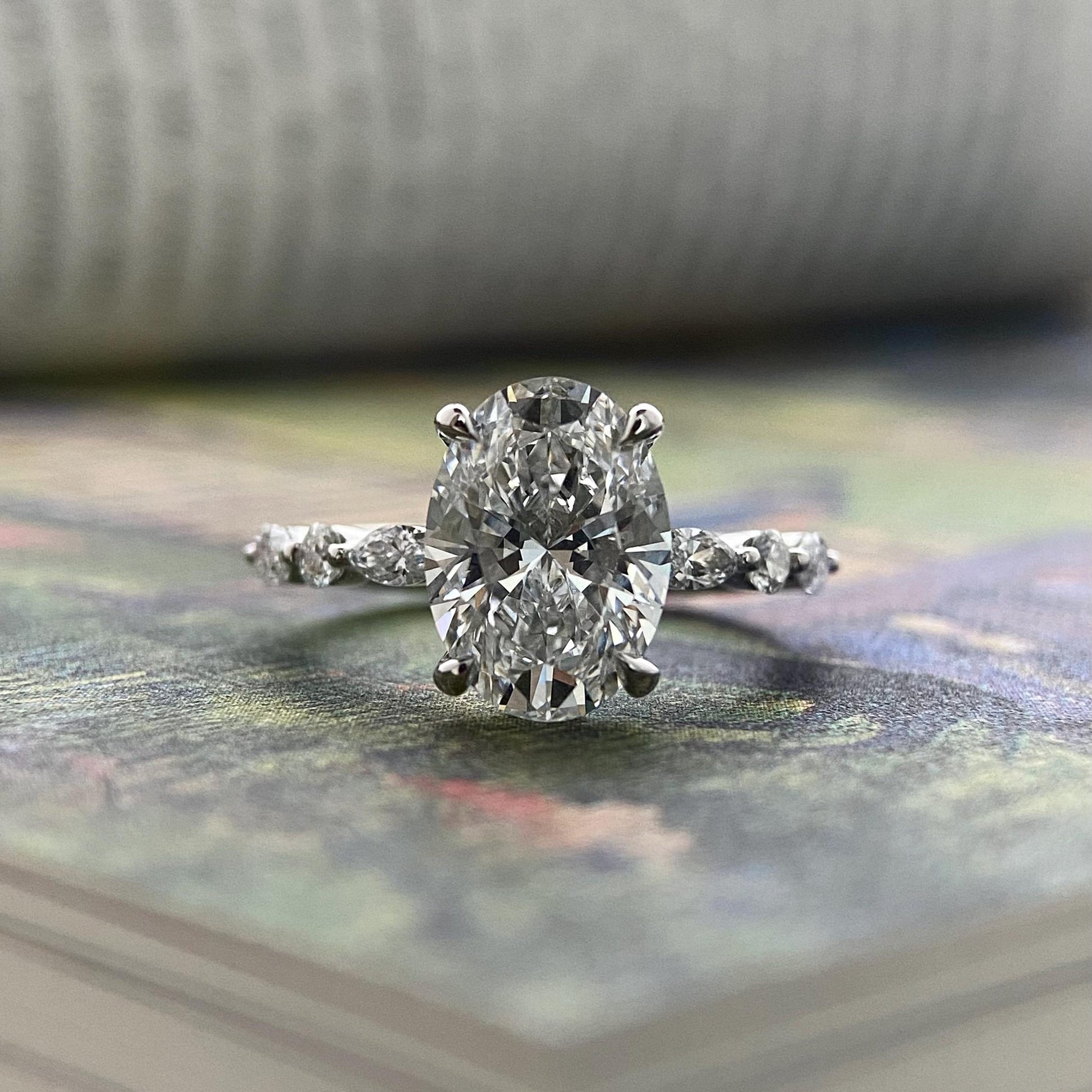 Oval CVD diamond engagement ring in dainty setting