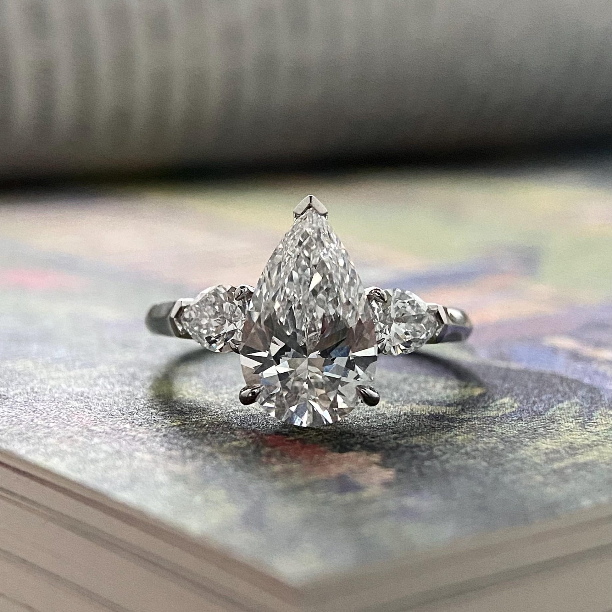Pear cut CVD diamond three stone style engagement ring