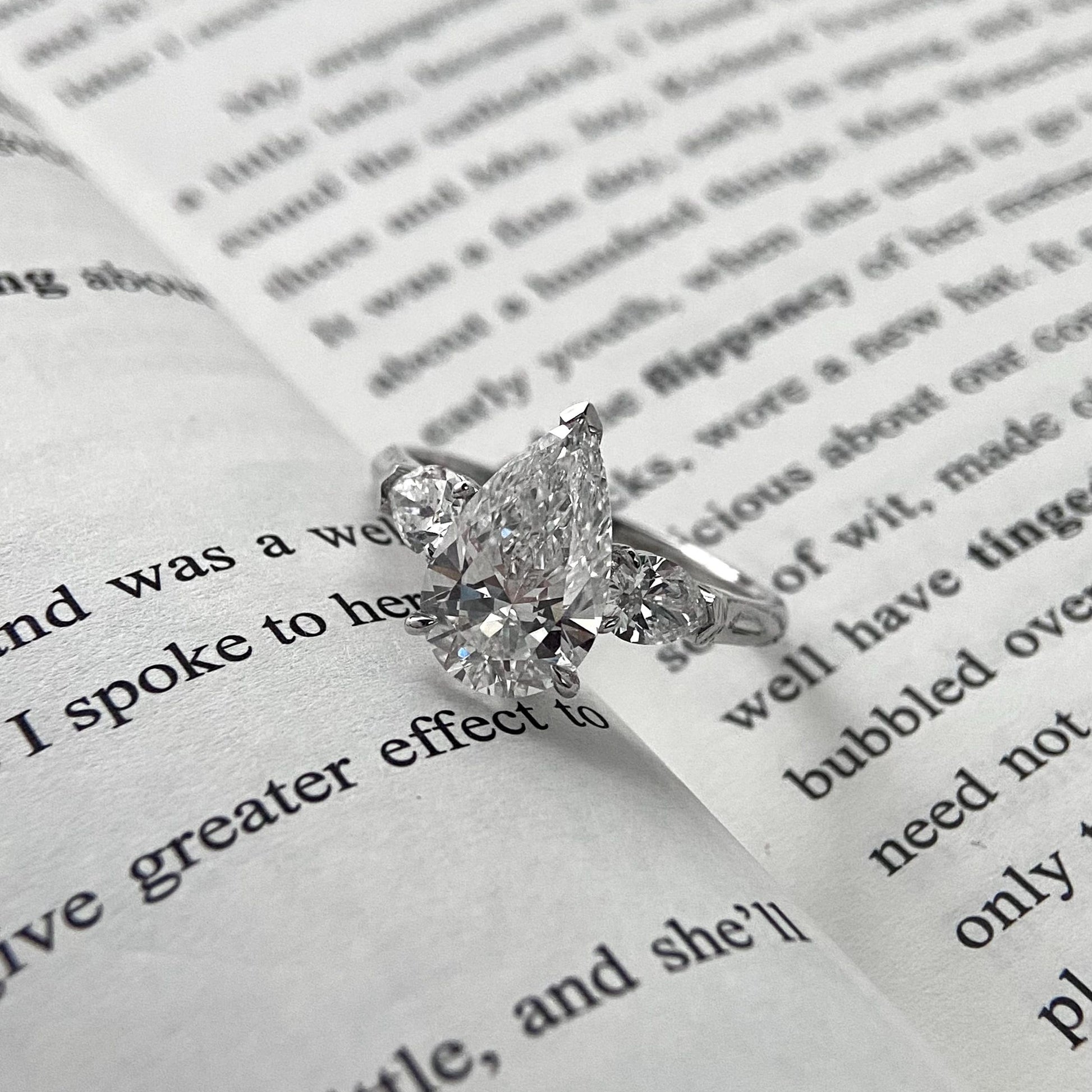 Pear cut CVD diamond three stone style engagement ring