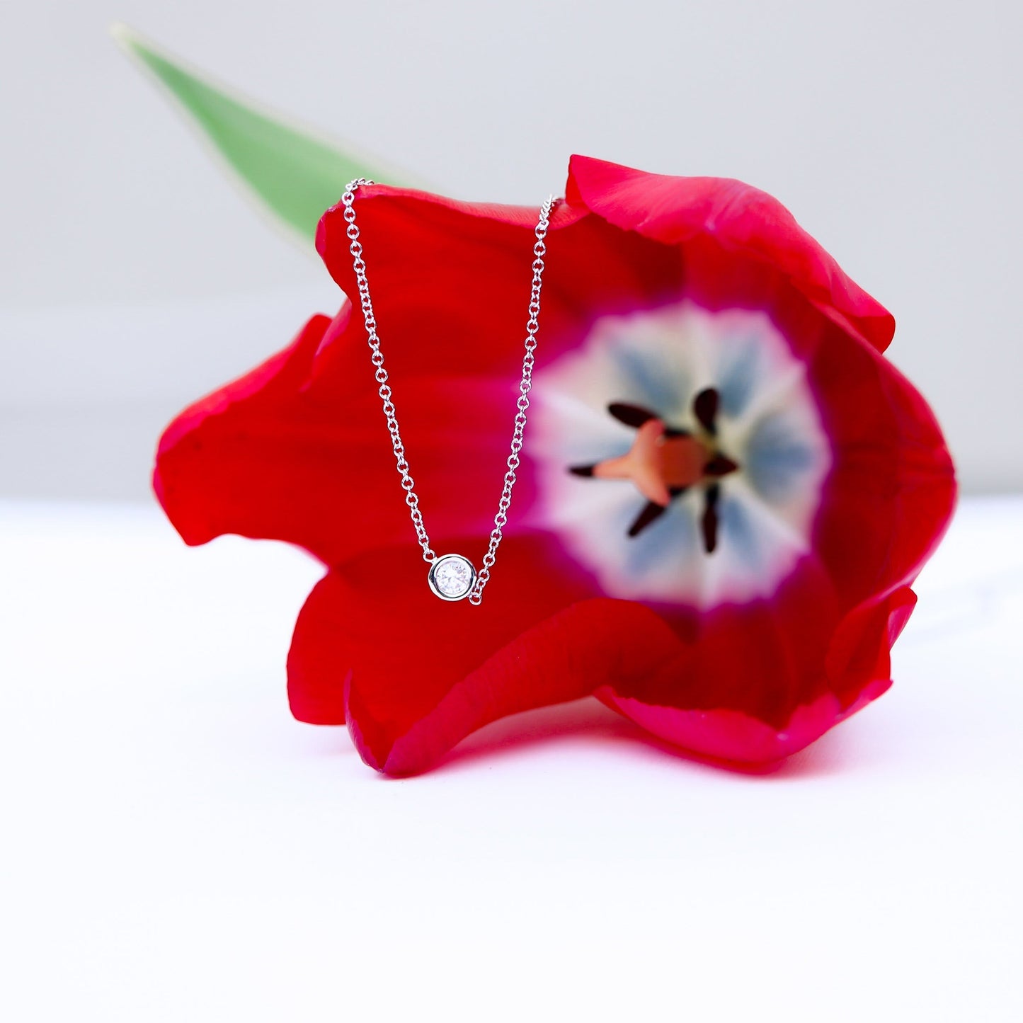 Single Bezel Necklace with 0.10 TCW Floating Cosmopolitan Round Cut Moissanite