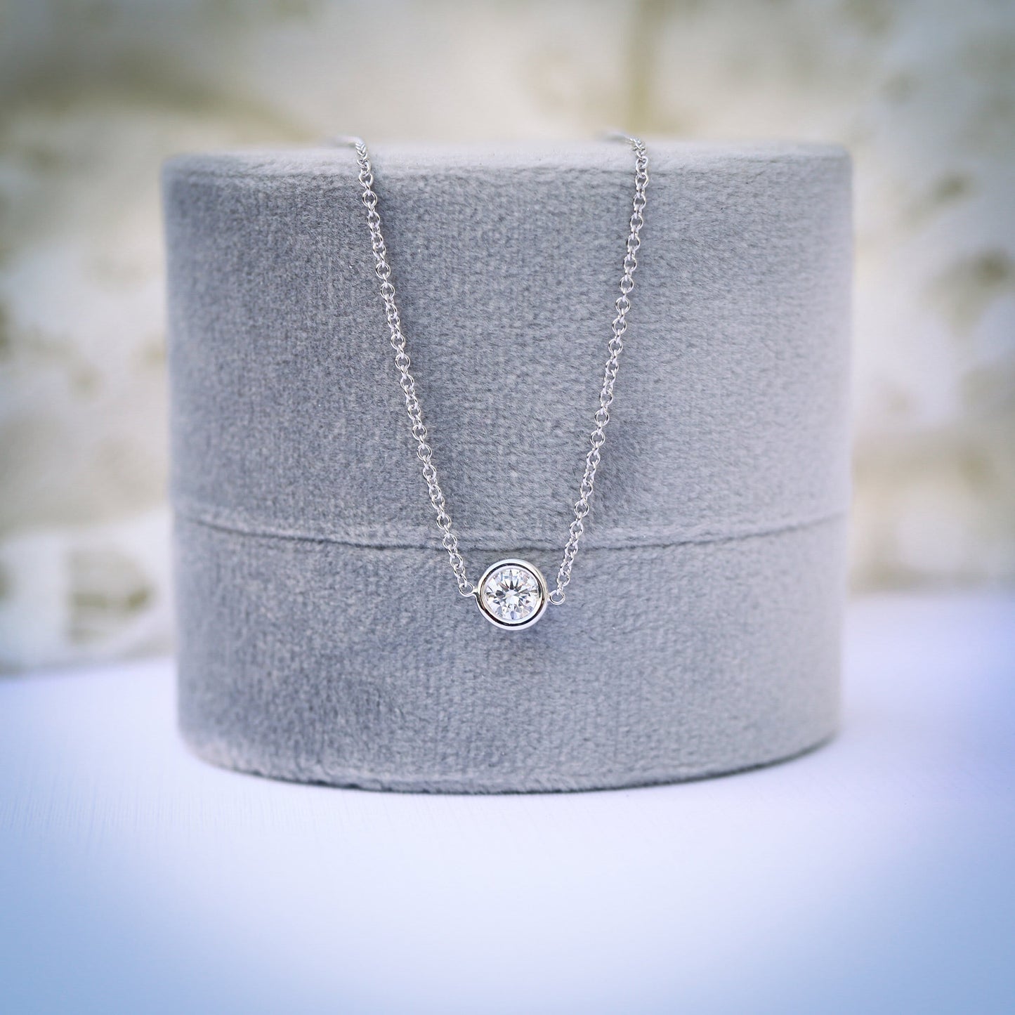 Single Bezel Necklace with 0.10 TCW Floating Cosmopolitan Round Cut Moissanite